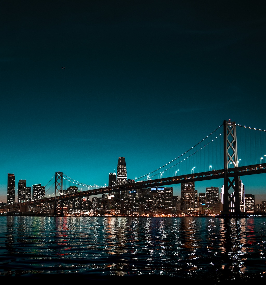 The same city skyline and bridge photo after AI watermark removal, with no visible text overlay